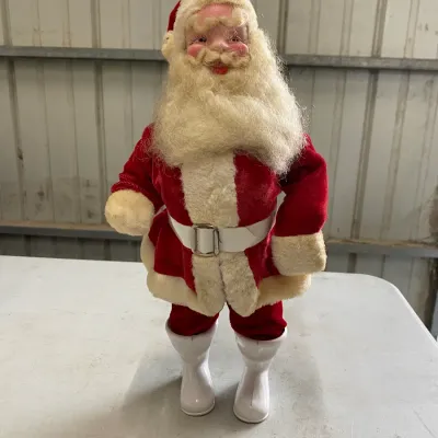 Vintage mid-century Santa Claus figure with a molded face, plush beard, red velvet suit, and white plastic boots.