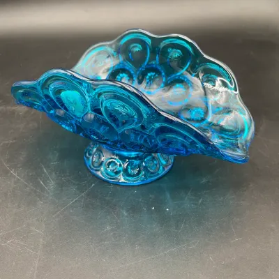 Vintage L.E. Smith blue glass banana boat bowl in the Moon and Stars pattern, featuring a ruffled rim and pedestal base.