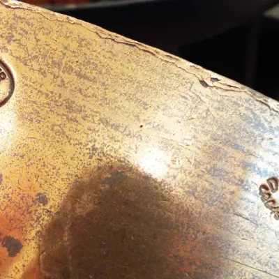 Antique tarnished metal item featuring engraved maker's marks for Bryn Mawr Hotel and C.D.H. & M. Co. N.Y.