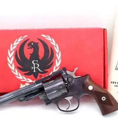 Ruger Security-Six double-action revolver with a blued finish and wooden grips, complete with its original red box and instruction manual.
