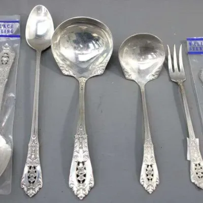 Wallace Sterling silver serving utensils in the Grande Baroque pattern, including a soup ladle, gravy ladle, cold meat fork, and iced tea...