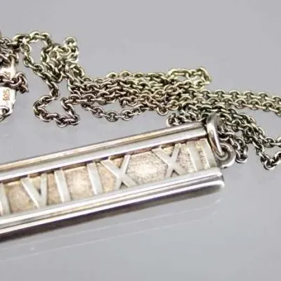 Tiffany & Co. sterling silver Atlas bar pendant necklace, featuring Roman numerals on a delicate link chain.