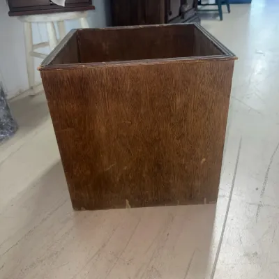 Sale Photo Thumbnail #44: Vintage square wooden wastebasket with a dark finish, showing some wear and scratches on the exterior.