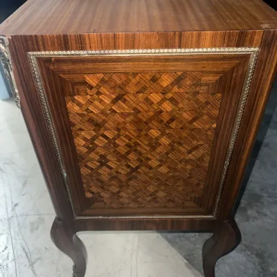 Sale Photo Thumbnail #83: Vintage French-style wooden side table featuring a parquetry inlaid side panel, decorative metal trim, and cabriole legs.