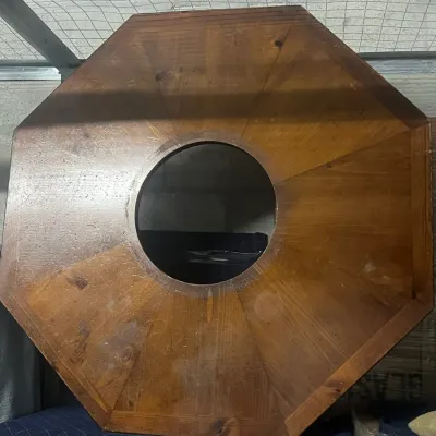 Sale Photo Thumbnail #63: Octagonal wooden table top with a circular center cutout, showing some surface wear and water rings.
