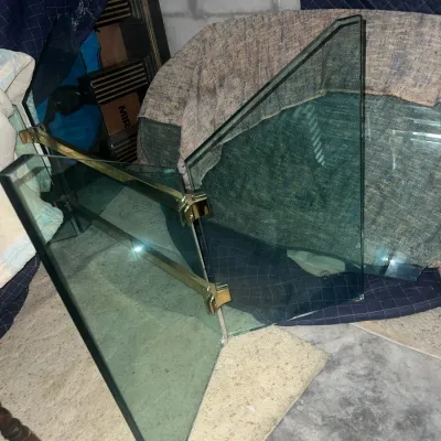 Sale Photo Thumbnail #67: Three-panel glass fireplace screen with polished brass hinges and beveled edges, showing some light wear.