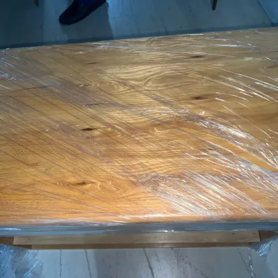 Sale Photo Thumbnail #51: Light-colored wooden tabletop with a prominent grain pattern, wrapped in protective plastic film.