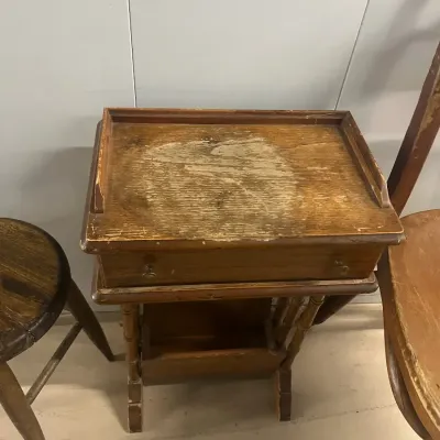 Sale Photo Thumbnail #39: Vintage wooden telephone table featuring a single drawer, a lower magazine rack, and a tray-style top with significant finish wear.