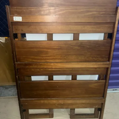 Sale Photo Thumbnail #57: Folding wooden bookcase with a warm brown finish, featuring three shelves and a slatted back design.