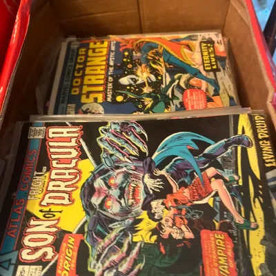 Sale Photo Thumbnail #96: Vintage comic books in a cardboard box, featuring Atlas Comics' Fright #1 "Son of Dracula" from June 1975 and Marvel Comics' Doctor Strange #180 from June 1969.