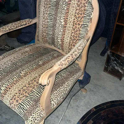 Sale Photo Thumbnail #82: Vintage French provincial style armchair featuring mixed animal print upholstery in zebra and leopard patterns, set in a light wood frame.