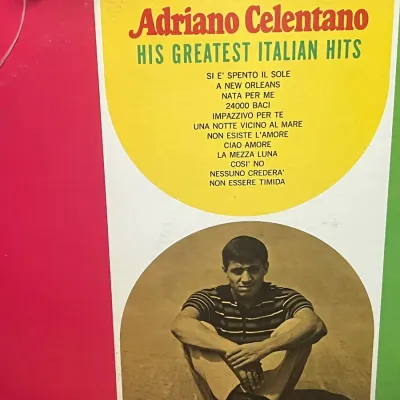 Sale Photo Thumbnail #75: Vintage vinyl record album cover for Adriano Celentano's "His Greatest Italian Hits," featuring a colorful red, white, and green Italian flag motif with a tracklist and a photo of the artist.