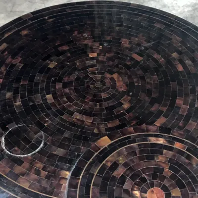 Sale Photo Thumbnail #68: Mid-century modern round coffee table featuring a dark tortoiseshell-style tiled mosaic top in concentric circular patterns.