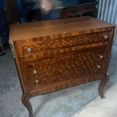 Sale Photo Thumbnail #85: French Provincial style three-drawer commode featuring parquetry wood inlay, cabriole legs, and ornate brass hardware.