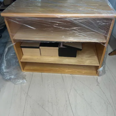 Sale Photo Thumbnail #46: Light oak finish wooden bookcase with adjustable shelves, wrapped in protective plastic film for transport.