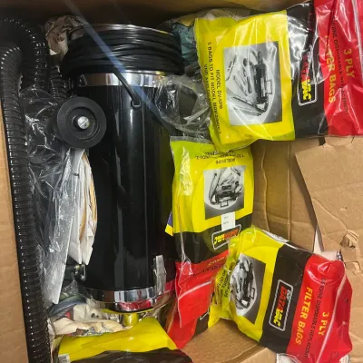 Sale Photo Thumbnail #6: Metro DataVac canister vacuum cleaner with hose and several packages of replacement 3-ply filter bags, stored in a cardboard box.