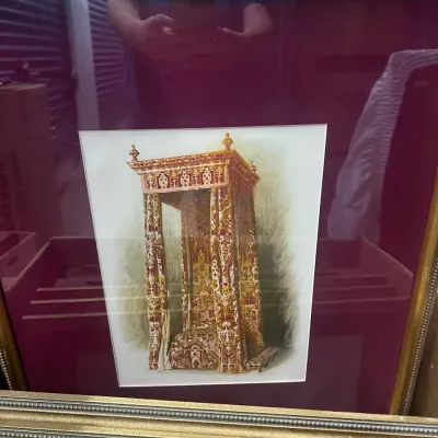 Sale Photo Thumbnail #19: Framed color lithograph depicting an ornate, canopied throne or bed with patterned drapery, set in a wide burgundy mat and a beaded gold frame.