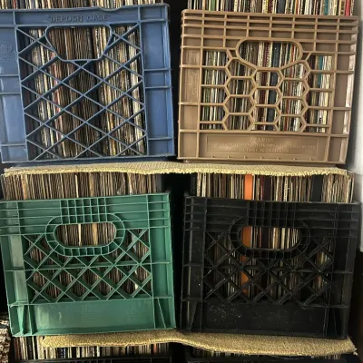 Sale Photo Thumbnail #92: Collection of vintage vinyl records stored in various colored plastic milk crates, stacked vertically.