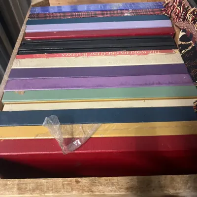 Sale Photo Thumbnail #10: Collection of vintage vinyl record box sets in various colors, stored in a wooden crate.