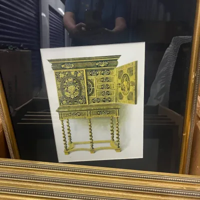 Sale Photo Thumbnail #25: Framed art print depicting an ornate, antique-style cabinet on a stand with barley twist legs, housed in a gold-finished frame with a black mat.