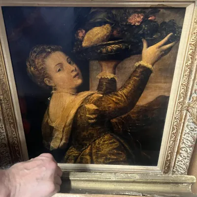 Sale Photo Thumbnail #24: Oil painting reproduction of Titian's 'Girl with a Bowl of Fruit', housed in an ornate, gilded plaster frame.