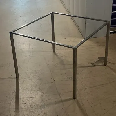 Sale Photo Thumbnail #28: Minimalist square metal table frame, likely designed for a glass or stone top, featuring a polished chrome finish.