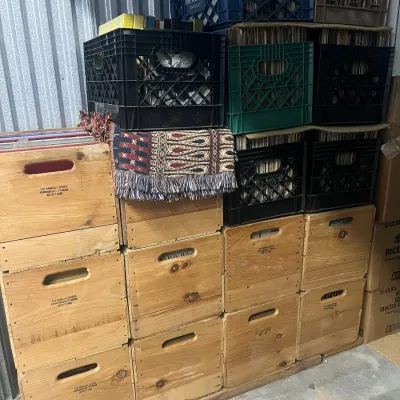 Sale Photo Thumbnail #13: Large collection of vinyl records stored in a stack of wooden Randall Boxes and various plastic milk crates.