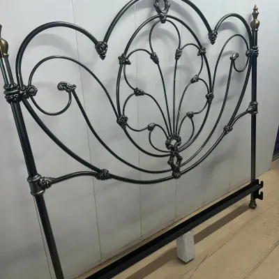 Sale Photo Thumbnail #35: Ornate black metal headboard featuring intricate scrollwork, floral accents, and brass-toned finials.