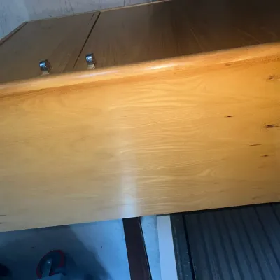 Sale Photo Thumbnail #50: Mid-century modern style wooden cabinet with a light oak finish and small metal pulls, showing some light surface wear.