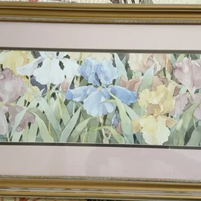 Framed watercolor print depicting a field of colorful irises, presented in a double mat and an ornate gold-finished frame.