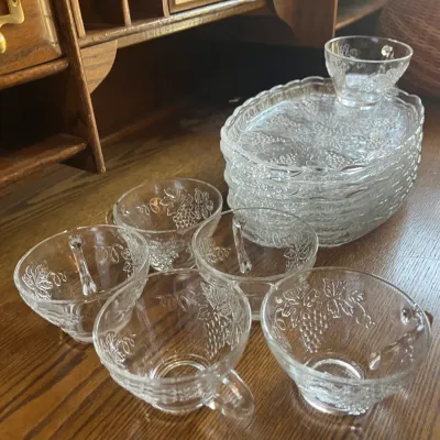 Vintage Indiana Glass Colony Harvest grape pattern snack set, featuring clear pressed glass cups and matching oval plates.