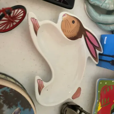 Whimsical rabbit-shaped ceramic dish, featuring painted details of a brown and white bunny with pink ears and paws.