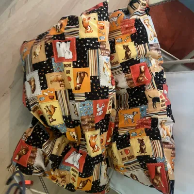 Pair of novelty throw pillows featuring a colorful patchwork dog-themed pattern with various breeds and bone motifs.