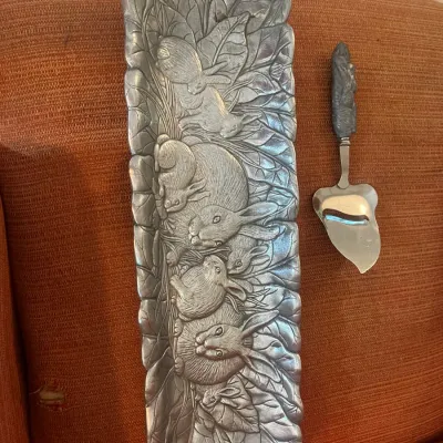 Arthur Court pewter rabbit-themed cracker tray and matching cheese slicer, featuring detailed relief carvings of rabbits and cabbage leaves.