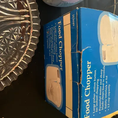 Vintage electric food chopper in its original blue box, model JE3049, featuring a 1.5 cup capacity and safety interlock lid.