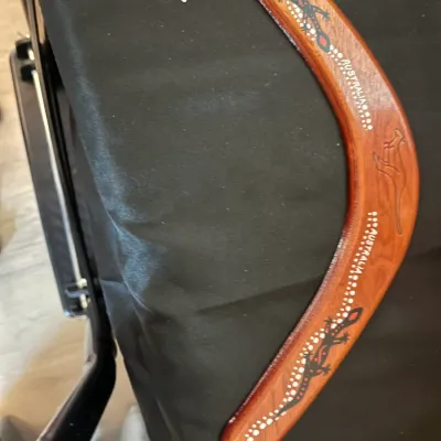 Handcrafted wooden Australian boomerang featuring painted lizard motifs, dot art, and an engraved kangaroo.