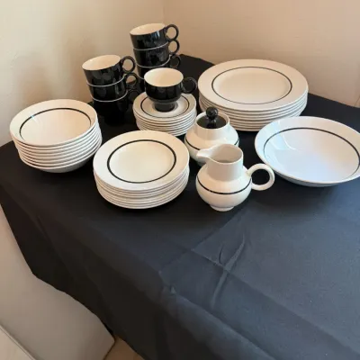 Vintage mid-century modern dinnerware set featuring a minimalist black and white design with thin black bands, including plates, bowls,...