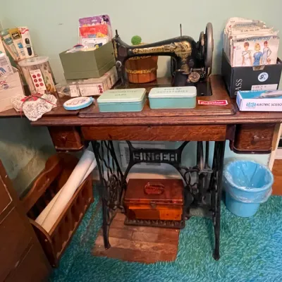Sale Photo Thumbnail #67: Antique Singer "Sphinx" treadle sewing machine and table with lots of vintage sewing patterns