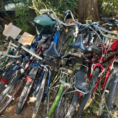 Assortment of vintage multi-speed bicycles including road and commuter models parked outdoors.