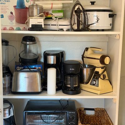 Sale Photo Thumbnail #10: Assorted kitchen appliances on white shelving, including a vintage Sunbeam stand mixer, Oster toaster, Hamilton Beach coffee maker, and Euro-Pro toaster oven.