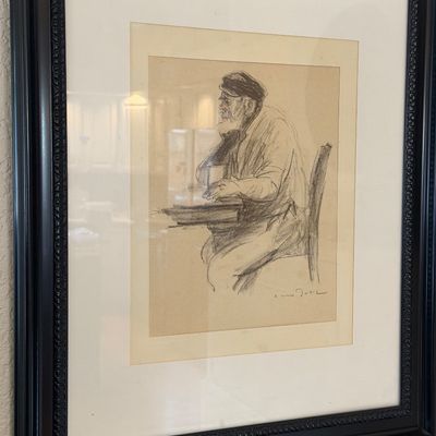 Sale Photo Thumbnail #13: Framed charcoal or pencil sketch depicting a seated, bearded man in profile, signed by the artist and presented in a black ornate frame with a white mat.