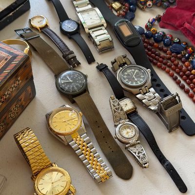 Sale Photo Thumbnail #7: Assortment of vintage and modern wristwatches, including a Citizen diver's watch, a gold-tone La Express watch, and various leather and metal band styles.