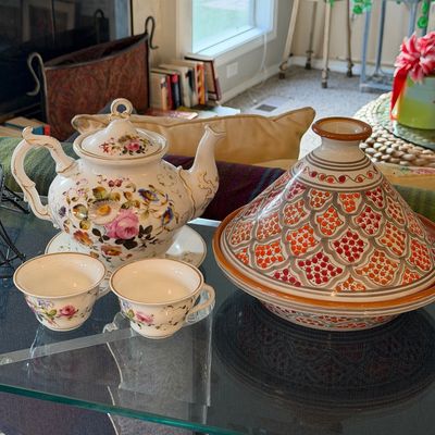 Sale Photo Thumbnail #21: Vintage floral porcelain teapot with two matching teacups, shown alongside a hand-painted ceramic Moroccan tagine on a glass tabletop.
