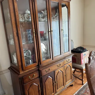 Sale Photo Thumbnail #128: Traditional cherry wood china cabinet featuring glass-front display doors, brass hardware, and lower storage cabinets and drawers.