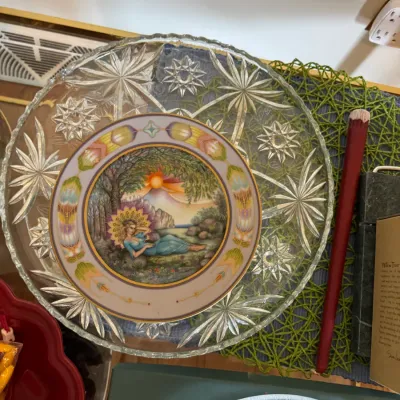 Sale Photo Thumbnail #161: Vintage fantasy-themed collector plate featuring an illustrated maiden, resting on a large cut-glass platter with starburst patterns.