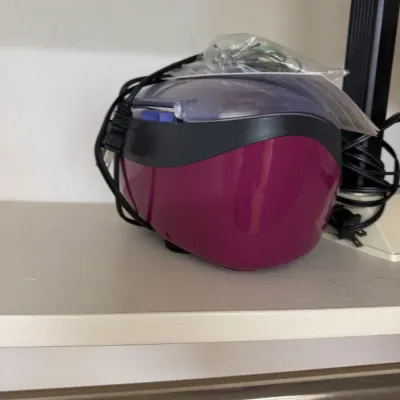 Conair True Glow paraffin bath in a magenta and black finish, complete with power cord and accessories.
