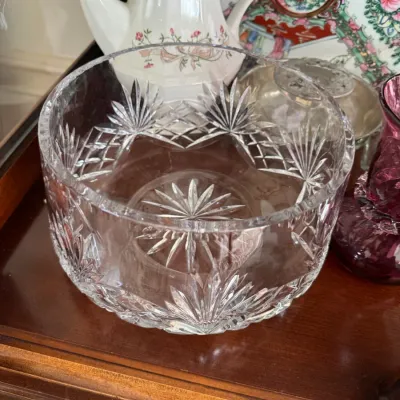 Sale Photo Thumbnail #129: Vintage cut crystal bowl featuring a starburst and diamond pattern, displayed alongside other decorative glassware and porcelain.