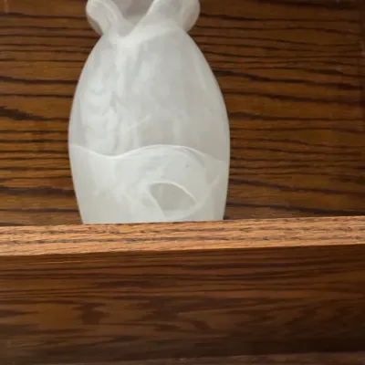Sale Photo Thumbnail #172: Frosted white art glass vase with a marbled, swirling pattern, displayed on a wooden shelf.