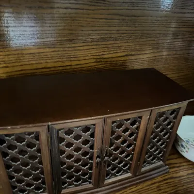 Sale Photo Thumbnail #189: Vintage wooden jewelry box featuring four lattice-work doors and a dark finish, showing minor wear.