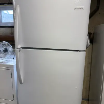 White Frigidaire top-freezer refrigerator in clean, working condition.